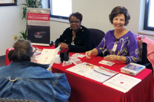 Program 60 volunteers at an information table